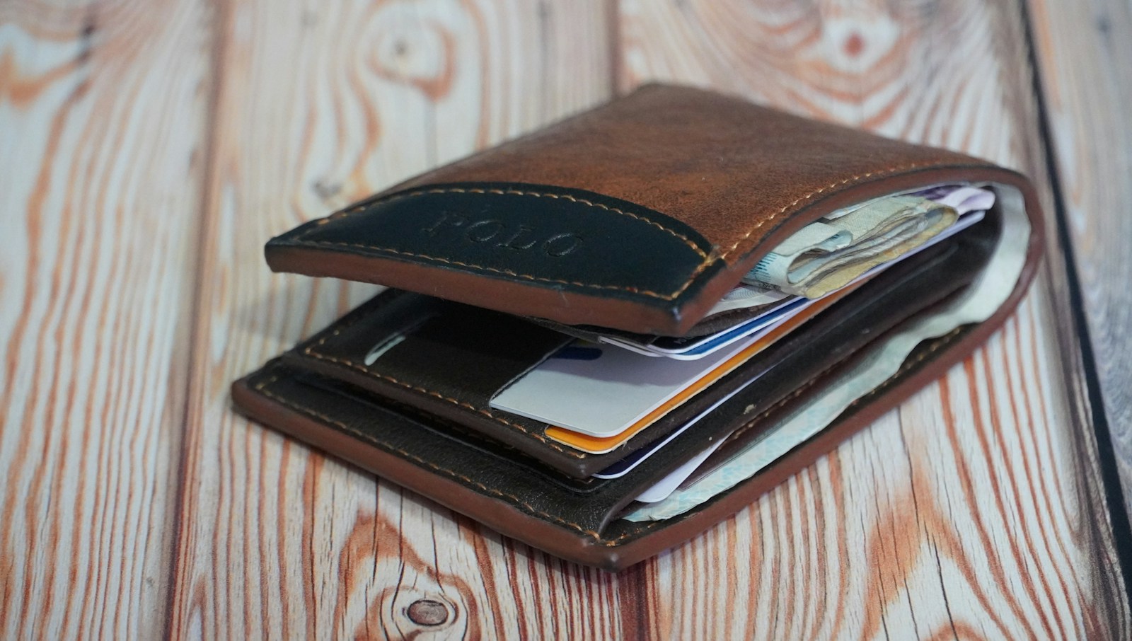 a wallet is open on a wooden table
